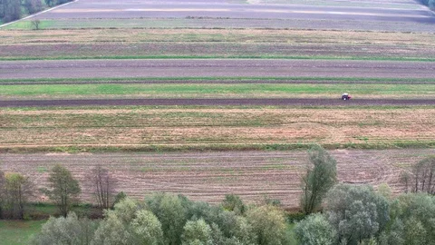 Tractor working on a fields, areal footage of landscape Stock Footage 98455380