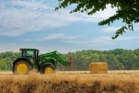 Tractor working on fields harvesting crop Stock Photos