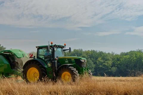 Tractor working on fields harvesting crop Stock Photos