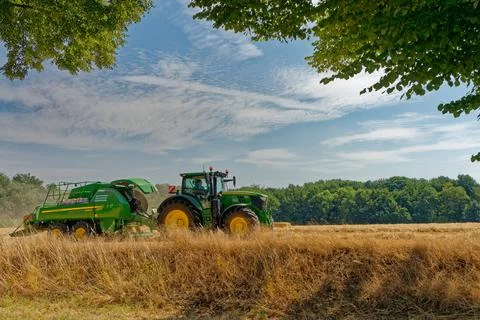 Tractor working on fields harvesting crop Stock Photos