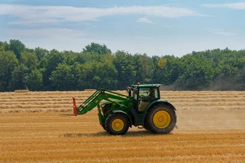 Tractor working on fields harvesting crop Stock Photos