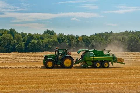 Tractor working on fields harvesting crop Stock Photos