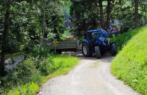 A tractor working in the fields high in the mountains Stock Photos