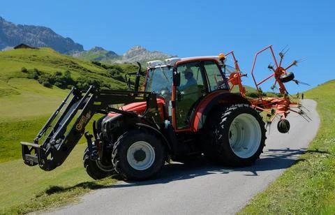 A tractor working in the fields high in the mountains Stock Photos