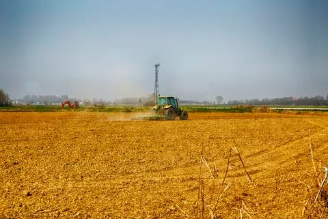 Tractor working in the fields Stock Photos