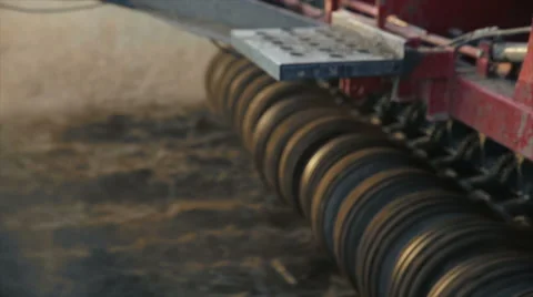 Tractor working in the grain fields - tight shot of the wheels - sunset flare 動画素材 40243120