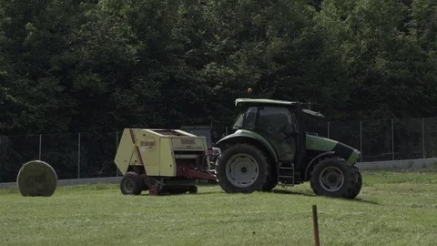 Tractor Working in a Green Field Stock Footage 80524855