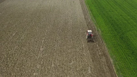 Tractor Working On Green Field Stock Footage 143159694