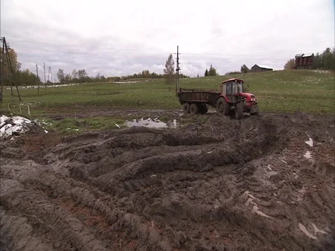 Tractor working hard in mud Stock Footage 2332466