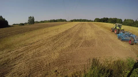 Tractor working in harvested field of rapa, 4K Stock Footage 53480894