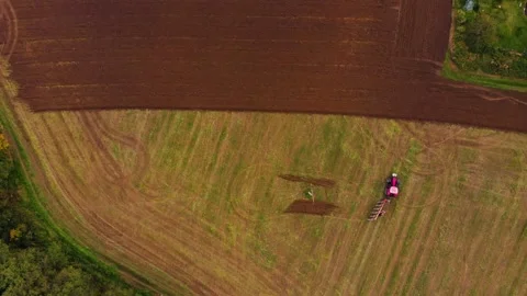 Tractor working one farm field drone view Stock Footage 141820124