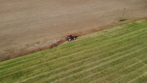 Tractor with working plow from a drone POV Stockbeeldmateriaal 115692662