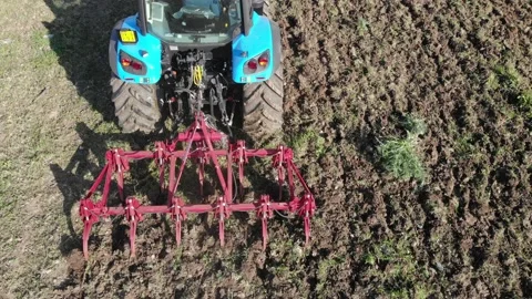 Tractor working the soil with 11 point tiller Stock Footage 151555388
