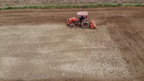 Tractor working on soil prepare for rice plantation aerial view Stock Footage 153234498