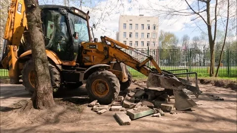 Tractor working in the yard of a residential building Stock Footage 239060757