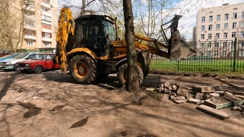 Tractor working in the yard of a residential building Stock Footage 239061027