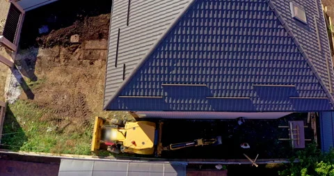 Tractor works on the construction of a cottage Stock Footage 144449141