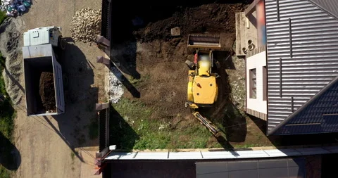 Tractor works on the construction of a cottage Stock Footage 144449432