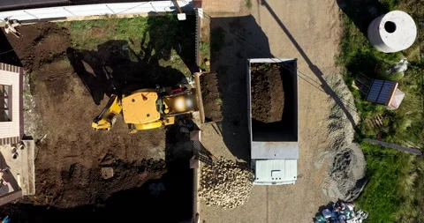 Tractor works on the construction of a cottage Stock Footage 144450250