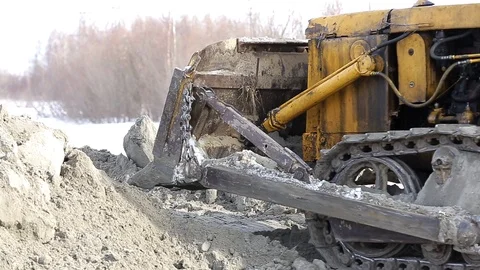 Tractor works on the construction site in the cold winter Stock Footage 115925268