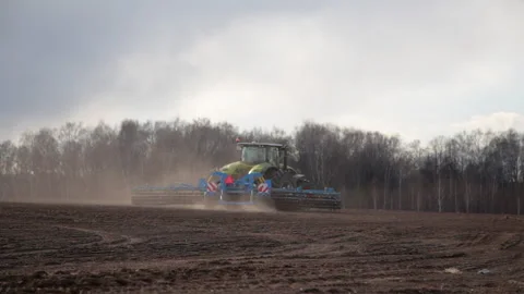 Tractor works in the field. Process of sowing cereals using special equipment. Stock Footage 146479823