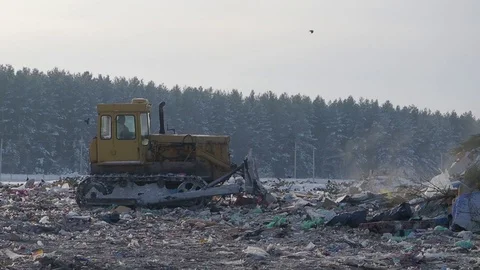 Tractor works at garbage dump in winter, Russia Stock Footage 101949019