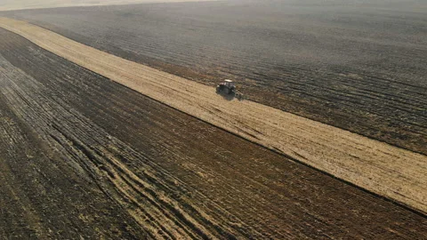 Tractors-agricultural unit performs the plowing, the cultivation of the soil of Stock Footage 106178160