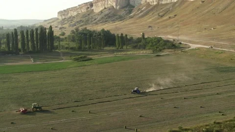 Tractors on a cliff farm Видео 158707552