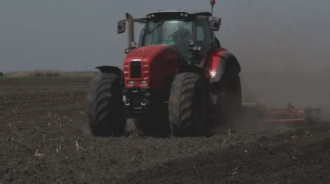 Tractors preparing land for sowing Stock Footage 64051167