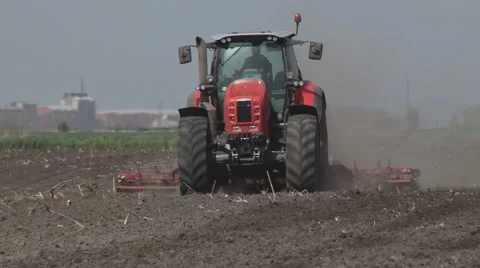 Tractors preparing land for sowing Stock Footage 64052140