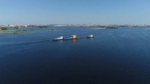 Tractors Pull a Barge on the River with A View Of the Big City. Air View. Tatars Video stock 127789924