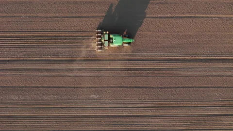 Tractors sowing the crop, using GPS antennas for straight parallel lines Stock Footage 272450967