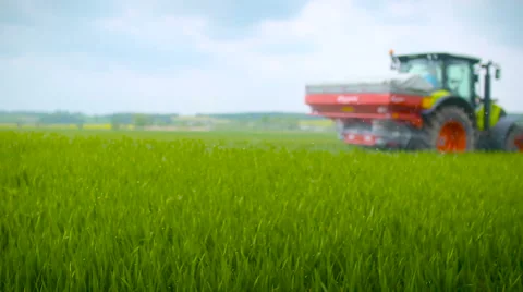Tractors sprayed with fertilizer Stock Footage 63944374