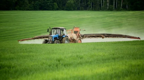 Tractors sprayed with fertilizer grass on the field Stock Footage 52519841
