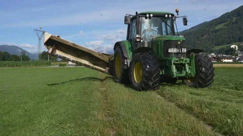 Tractors working on green field Stock Footage 67599745