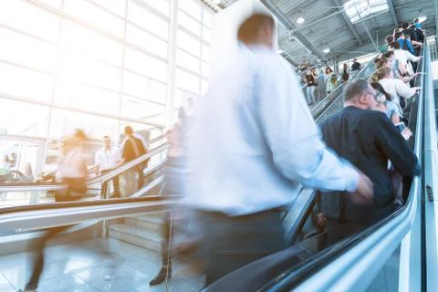 Trade fair visitors using a escalator Foto stock