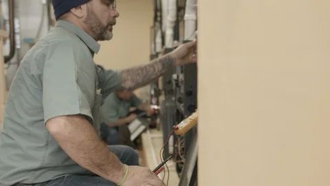 Trade school students learn to do maintenance and installation on HVAC Stock Footage 125085792