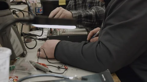Trade school students work on wiring electrical components Stock Footage 125389980