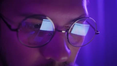 Trader analyst wearing eyeglasses working looking at computer screen reflecting Stock Footage 233005376