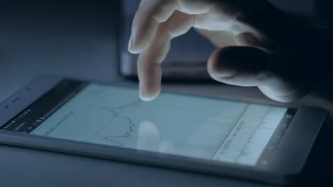 Trader analyzes the chart of bitcoin Stock Footage 88344856