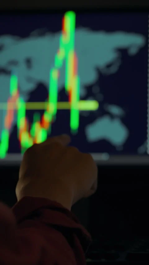 Trader analyzes global market trends on computer screen in the evening Stock Footage 331728568