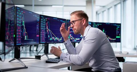 Trader Analyzes Negative Financial Data On Computer Screen, Worriedly Discuss 写真素材