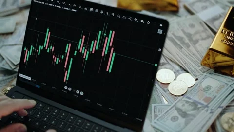 Trader analyzing forex market trends on tablet surrounded by gold bars and .. Stock Footage 337443120
