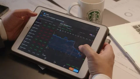 Trader Analyzing Stock Market Data on Tablet Screen Video stock 336551987