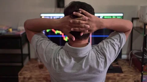 Trader from behind analyzing forex trading chart on monitor, buy and sell Video stock 342747942