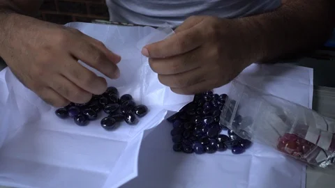 A trader displays gemstone or crystal in the trading market THAILAND. Stock-Footage 95774069