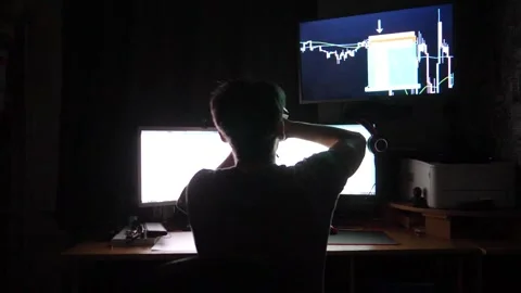 Trader engaged in cryptocurrency analysis, reacting to market changes with Video stock 347870716