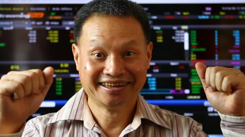 Trader  extremely glad with blurred stock exchange board background. Stock Footage 151889792