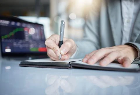 Trader, hands and writing notes in book on stock market chart or graph Stock Photos