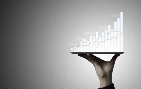 Trader holding Tablet and touching to technical graph chart for analysis st.. Stock Photos